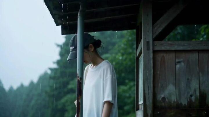 Превью промпта: A cinematic close-to-medium shot of a young East Asian woman standing under a weathered wooden porch…